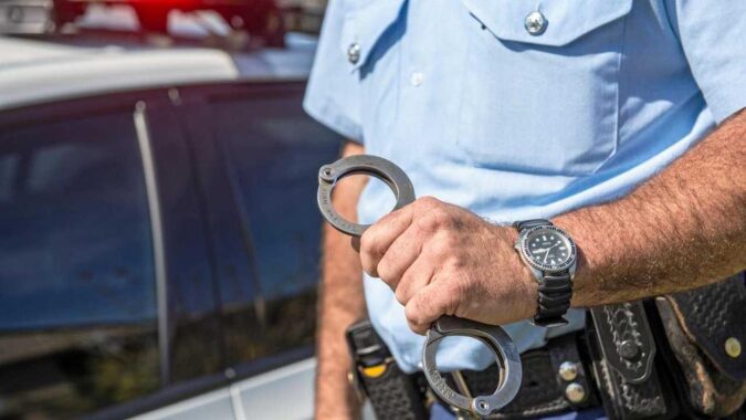 BailBlog Picture police officer holding handcuffs for criminal