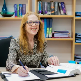 Amanda Brady sitting at desk taking notes